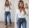 Model wears White Dressy Bodysuit with long sleeves and flattering wrap front .Bodysuit has a flattering shape enhancing gathered waist with gold clasp detailing and is a stretchy fabric